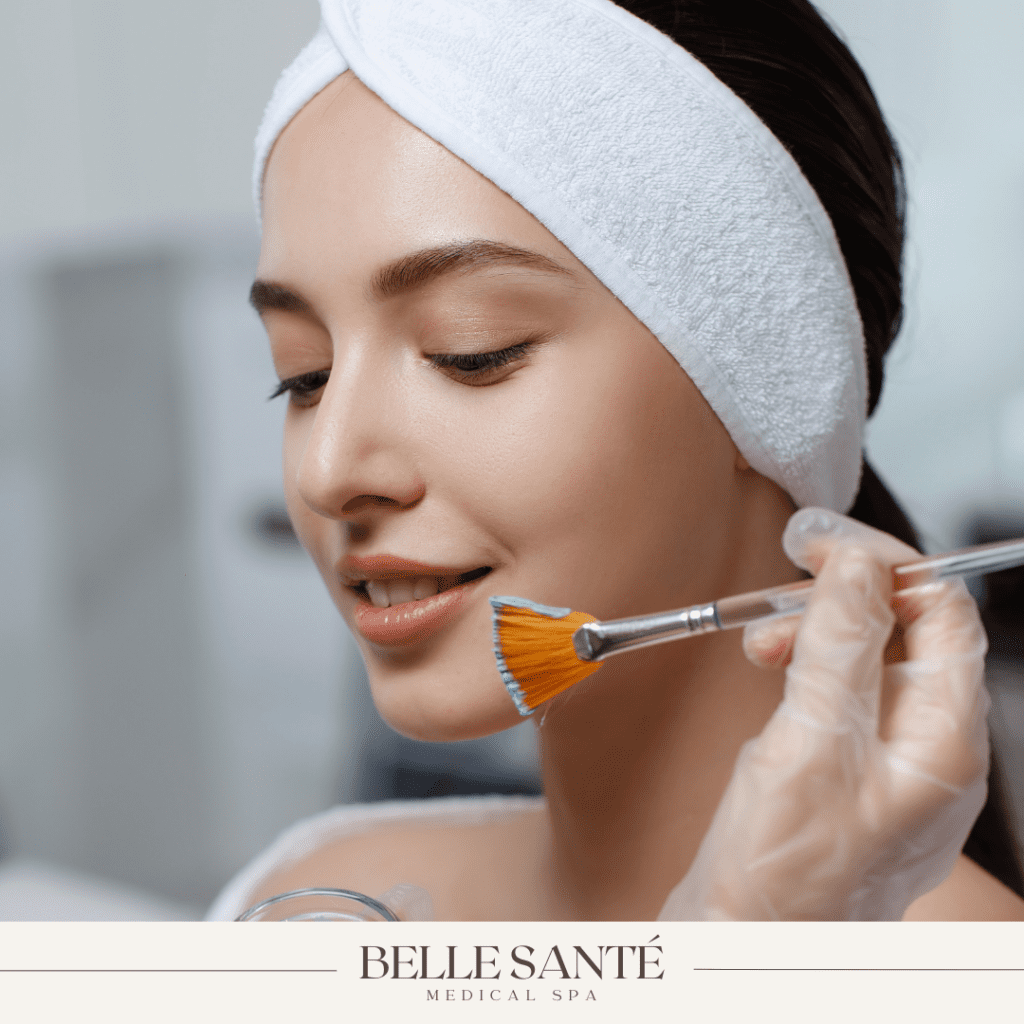 Young woman receiving chemical peel with Belle Santé Medical Spa logo.