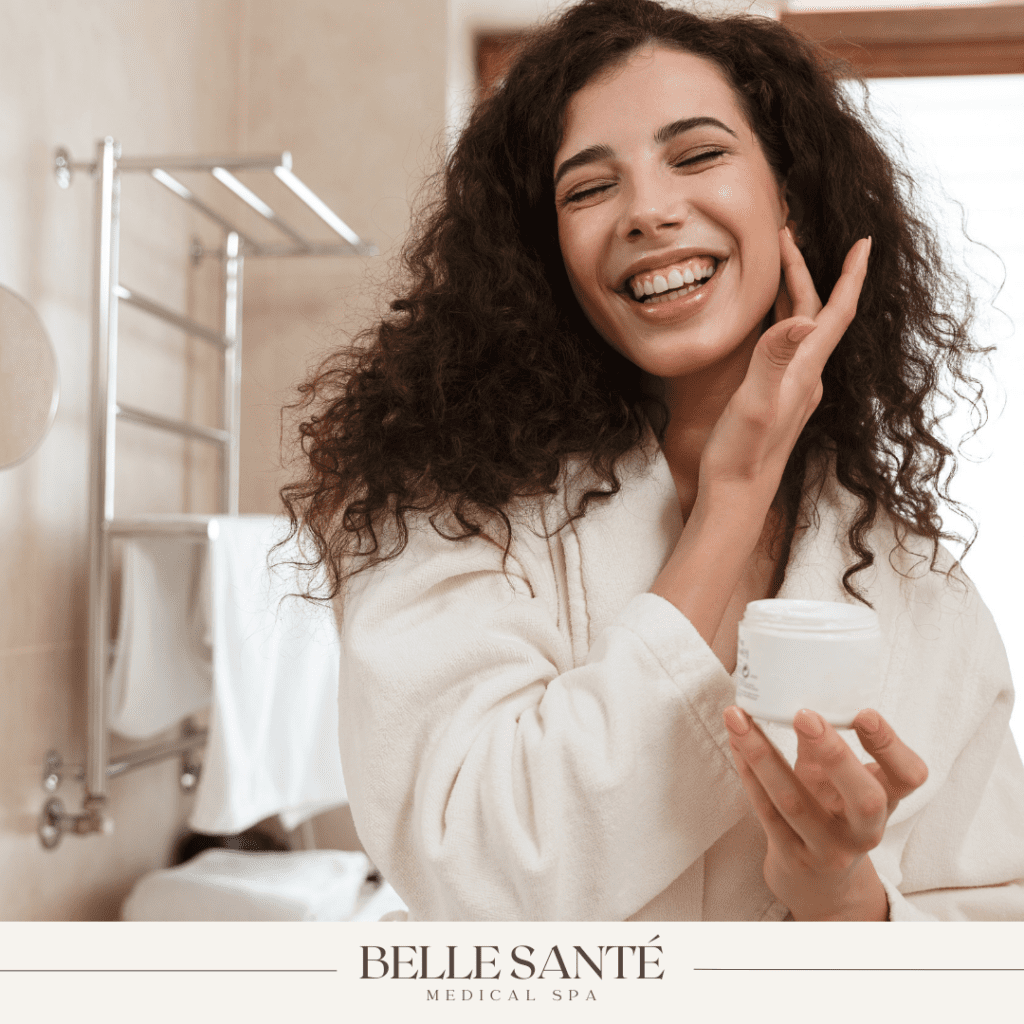 Woman applying peptide cream to her face.