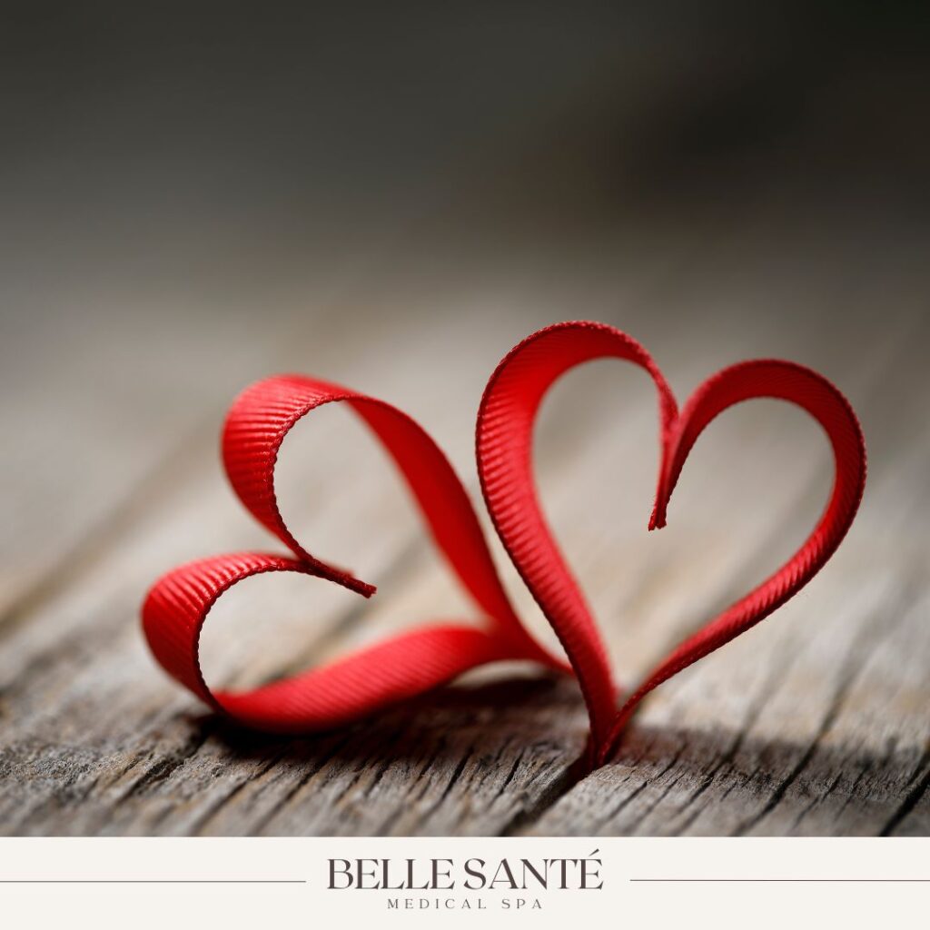 Two hearts made out of ribbons with the Belle Santé Medical Spa logo at the bottom.